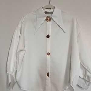 Elegant White Blouse with Gold Brooch